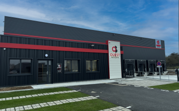 façade d'entrepôt, bardage gris foncé avec une bande rouge