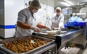 deux cuisiniers dans la cuisine centrale de laval qui cuisinent
